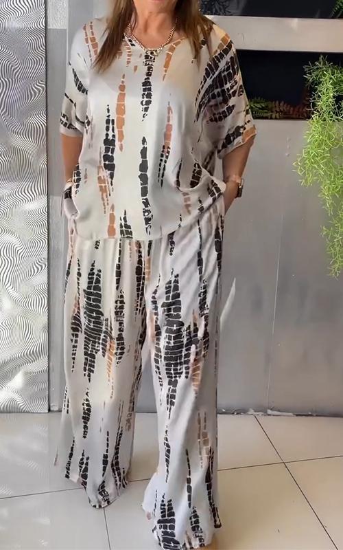A woman wearing a vivid printed matching top and trousers set.