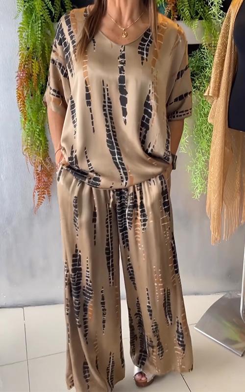 A woman wearing a vivid printed matching top and trousers set.