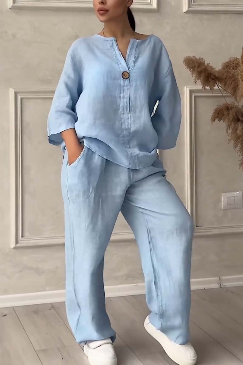 A woman wearing a loose relaxed top with matching wide-cut trousers.