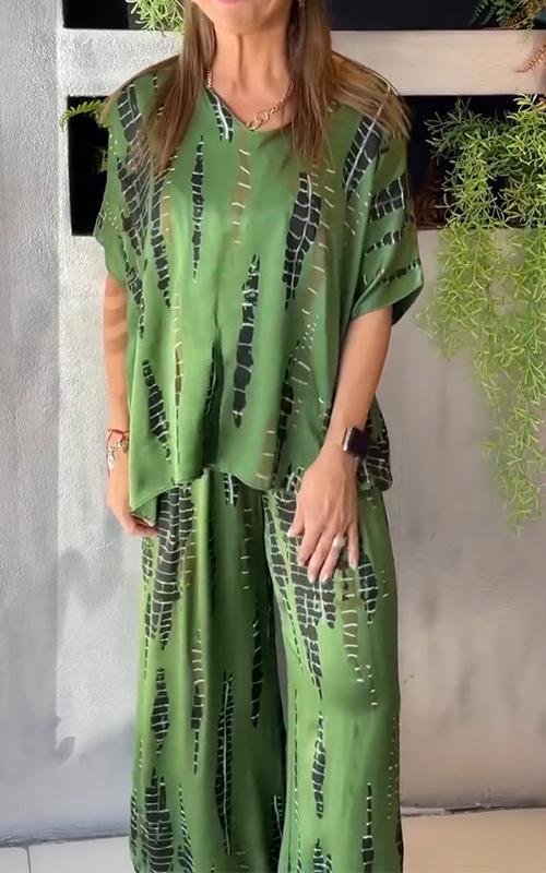 A woman wearing a vivid printed matching top and trousers set.