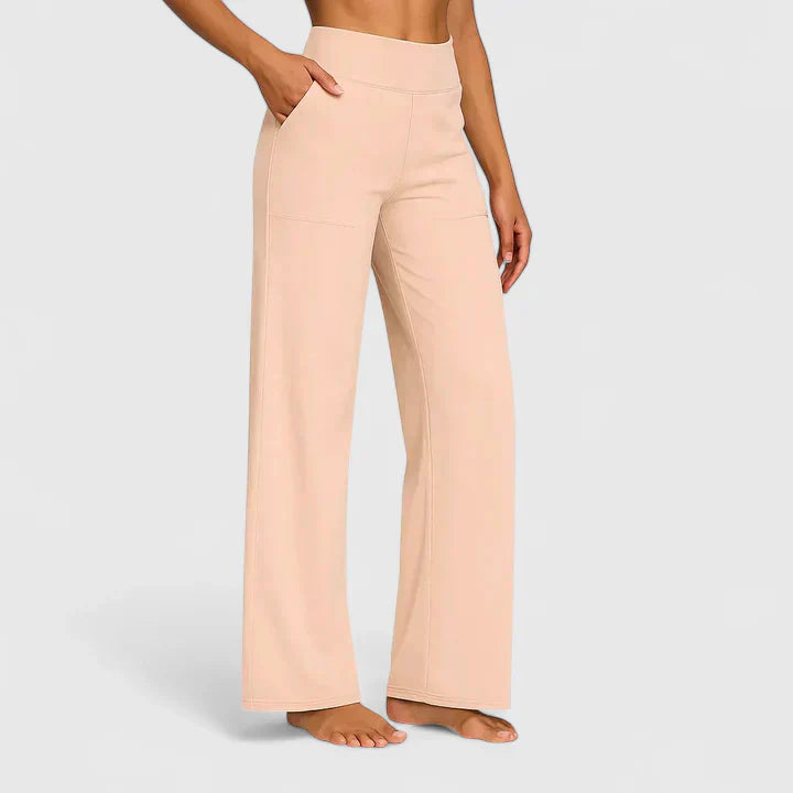 A woman in elegant straight-leg trousers with pockets, styled for a polished everyday look.
