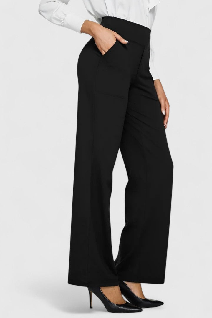 Woman wearing pull-on trousers with a soft blouse, relaxed and comfortable at home.