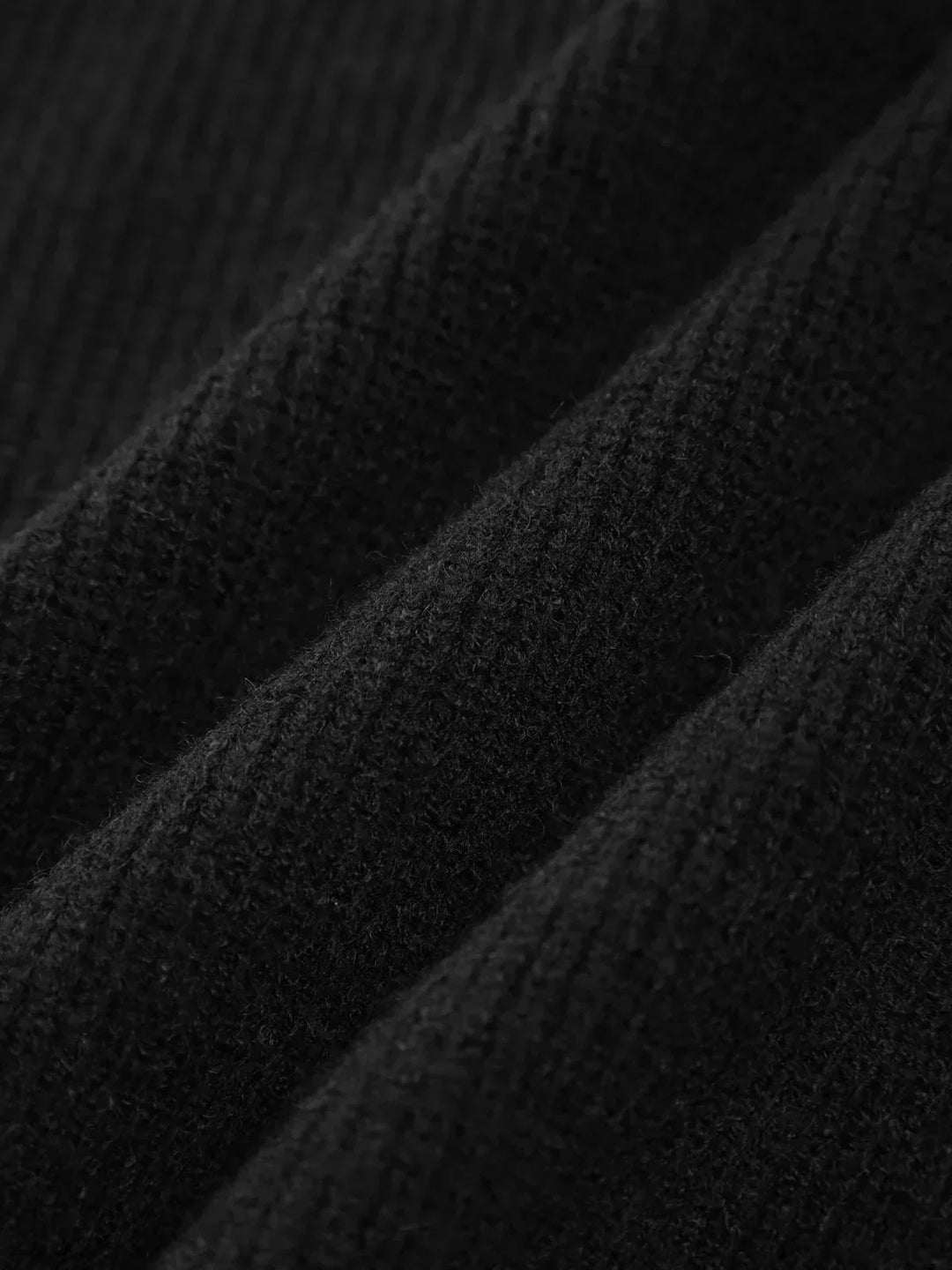A woman wearing an oversized mock-neck jumper with whipstitch detailing, cosy and stylish.