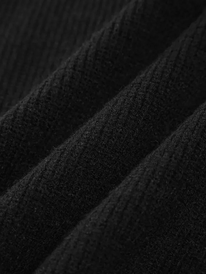 A woman wearing an oversized mock-neck jumper with whipstitch detailing, cosy and stylish.