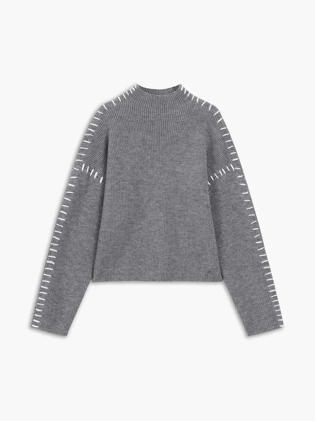 A woman wearing an oversized mock-neck jumper with whipstitch detailing, cosy and stylish.