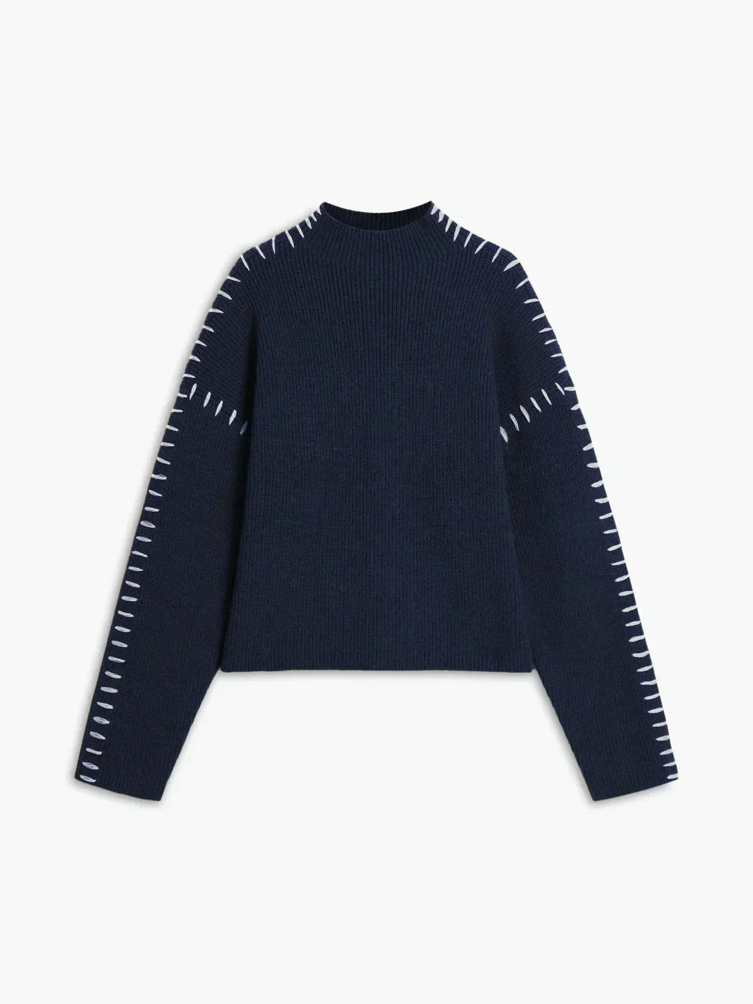 A woman wearing an oversized mock-neck jumper with whipstitch detailing, cosy and stylish.