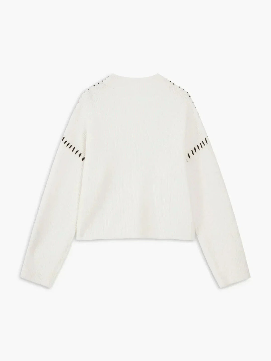 A woman wearing an oversized mock-neck jumper with whipstitch detailing, cosy and stylish.