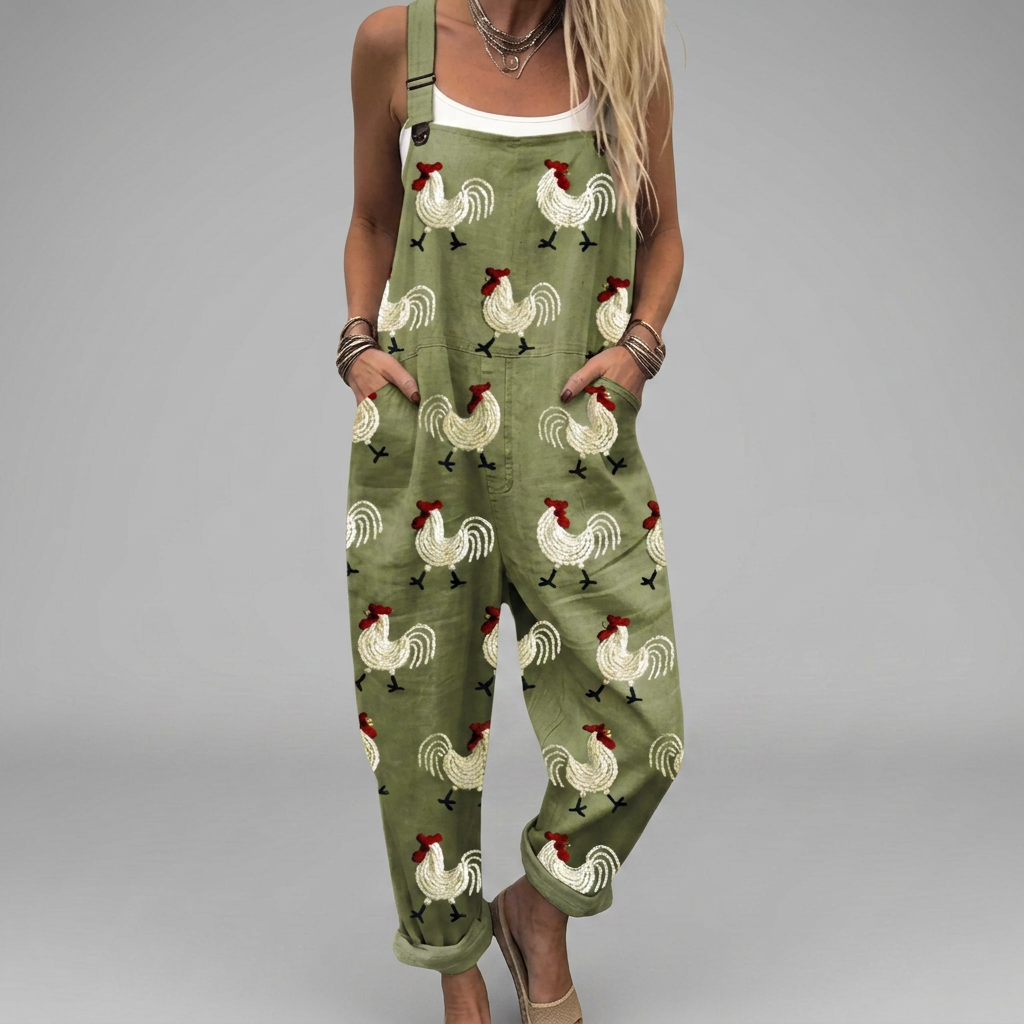 Wide-leg printed jumpsuit with warm tones, flowing silhouette and adjustable shoulder straps