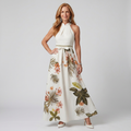 White botanical print halter maxi dress with a draped neckline and bow waist detail
