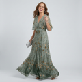 Sage green halter-neck midi dress with all-over floral print and loose flowing silhouette