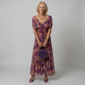Purple off-shoulder midi dress with draped neckline and gently flared skirt