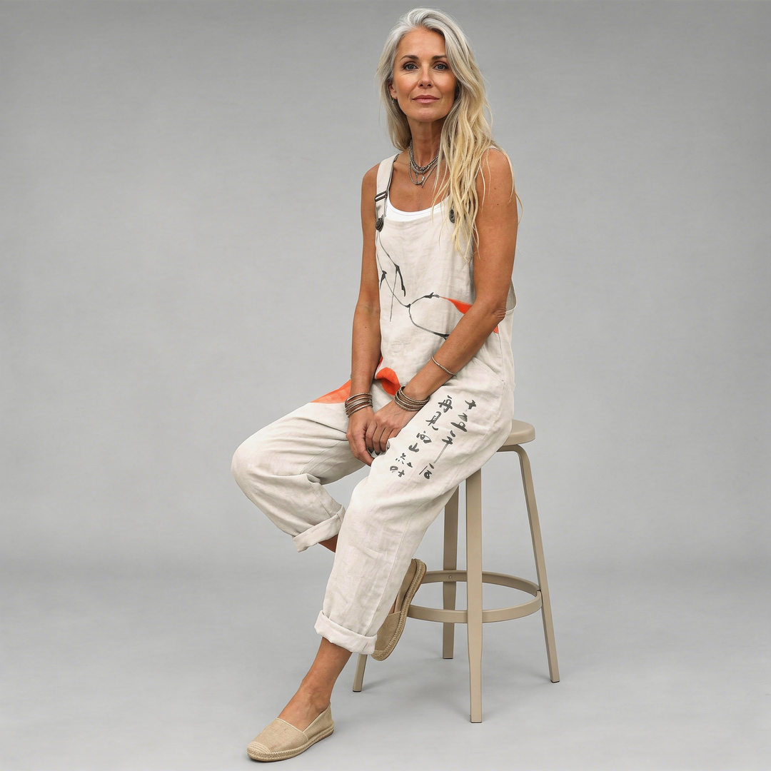 Woman wearing the Saoirse™ cream wide-leg dungarees featuring an artistic ink-brushwork print with orange circle accents.