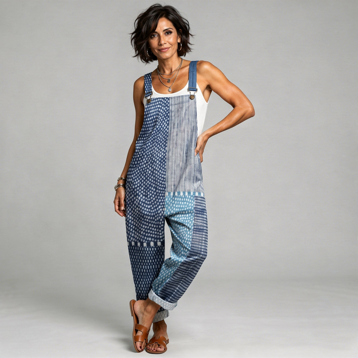 Woman wearing the Orla™ deep blue wide-leg dungarees in a boho patchwork of dots, stripes, and ornamental print.
