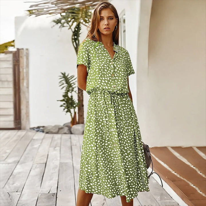 Woman wearing the Ursula™ printed summer midi dress with a flowing skirt, out for a bright summer stroll.