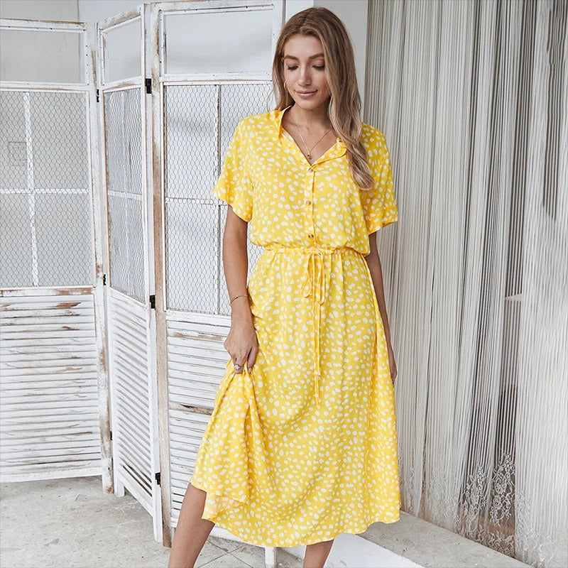 Woman wearing the Ursula™ printed summer midi dress with a flowing skirt, out for a bright summer stroll.