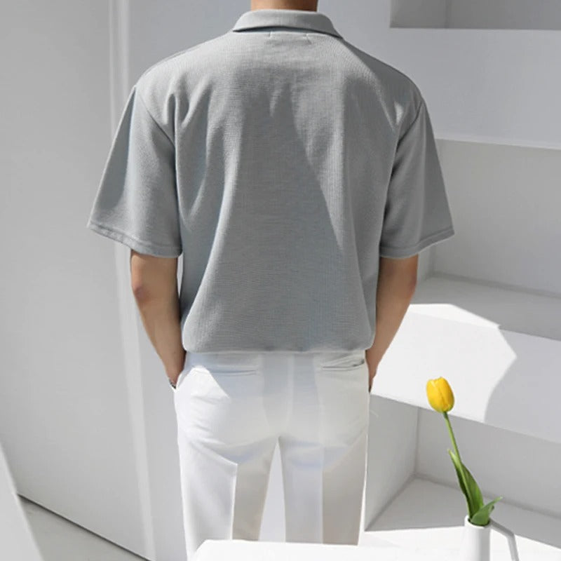 Men's oversized polo shirt in light grey with a partial button collar and relaxed silhouette