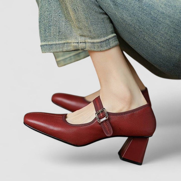 A woman in black Mary Jane shoes with a mid block heel, confident on an evening out.