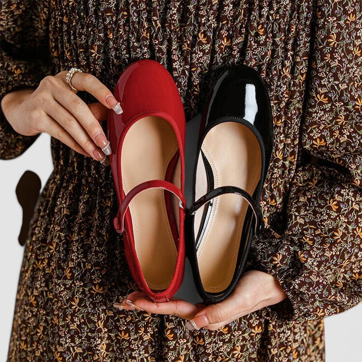 A woman wearing red Mary Jane shoes, comfortable and steady during a day of errands.