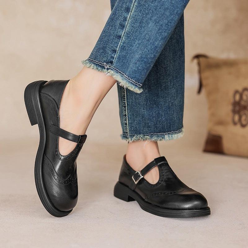 Vintage T-bar strap shoes in brown and black with a rounded toe and adjustable buckle