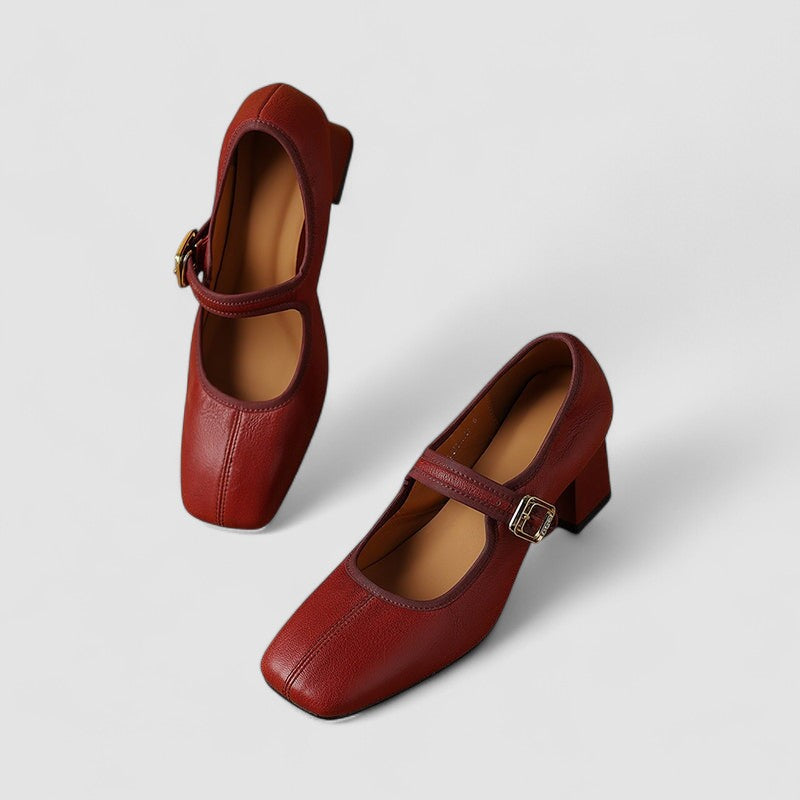 A woman in red Mary Jane shoes with a mid block heel, confident on an evening out.