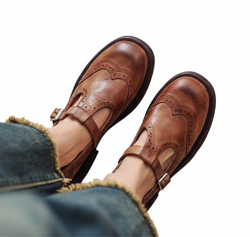 Women's vintage-style T-bar flat shoes in brown with an adjustable buckle strap