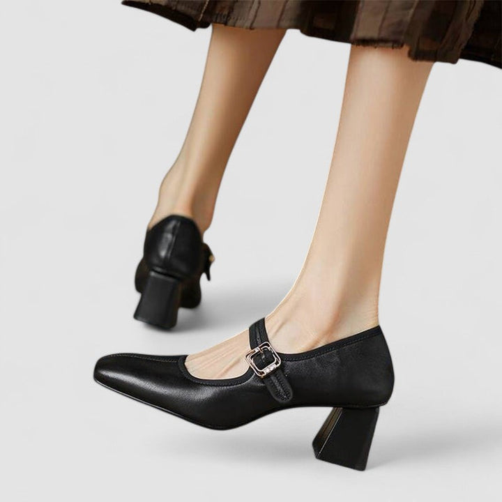 A woman in red Mary Jane shoes with a mid block heel, confident on an evening out.