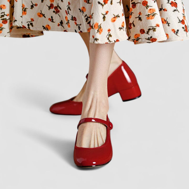 A woman wearing glossy black Mary Jane shoes with a low block heel, comfortable and steady during a day of errands.