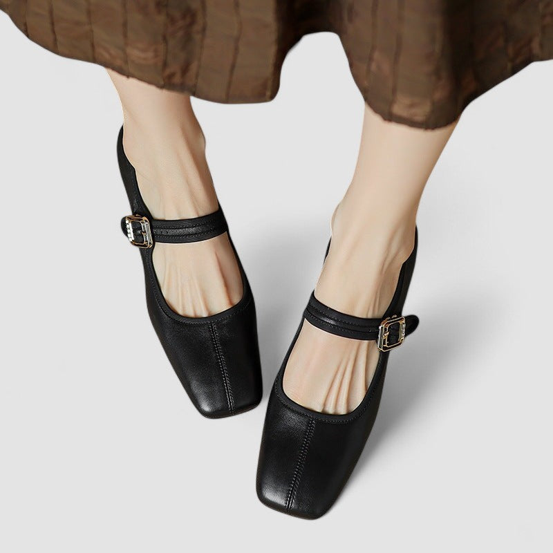 A woman in red Mary Jane shoes with a mid block heel, confident on an evening out.