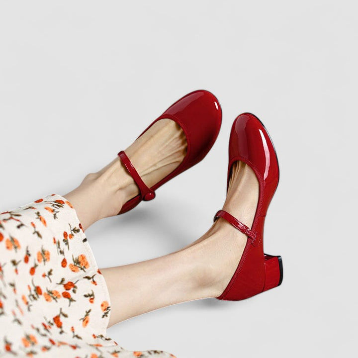 A woman wearing red Mary Jane shoes, comfortable and steady during a day of errands.