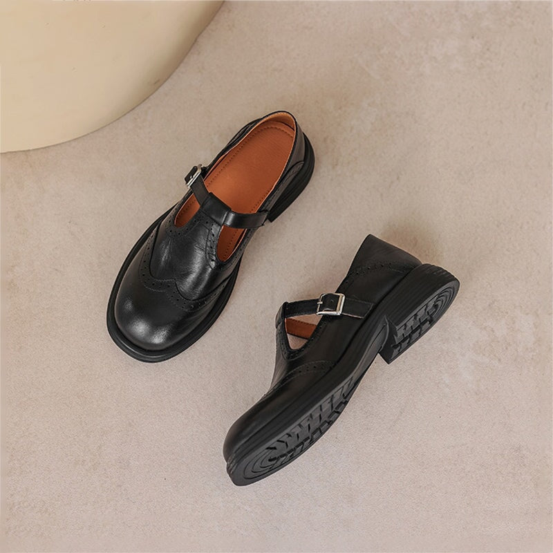 Vintage T-bar strap shoes in brown and black with a rounded toe and adjustable buckle