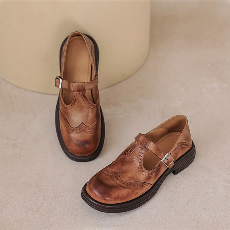 Vintage T-bar strap shoes in brown and black with a rounded toe and adjustable buckle