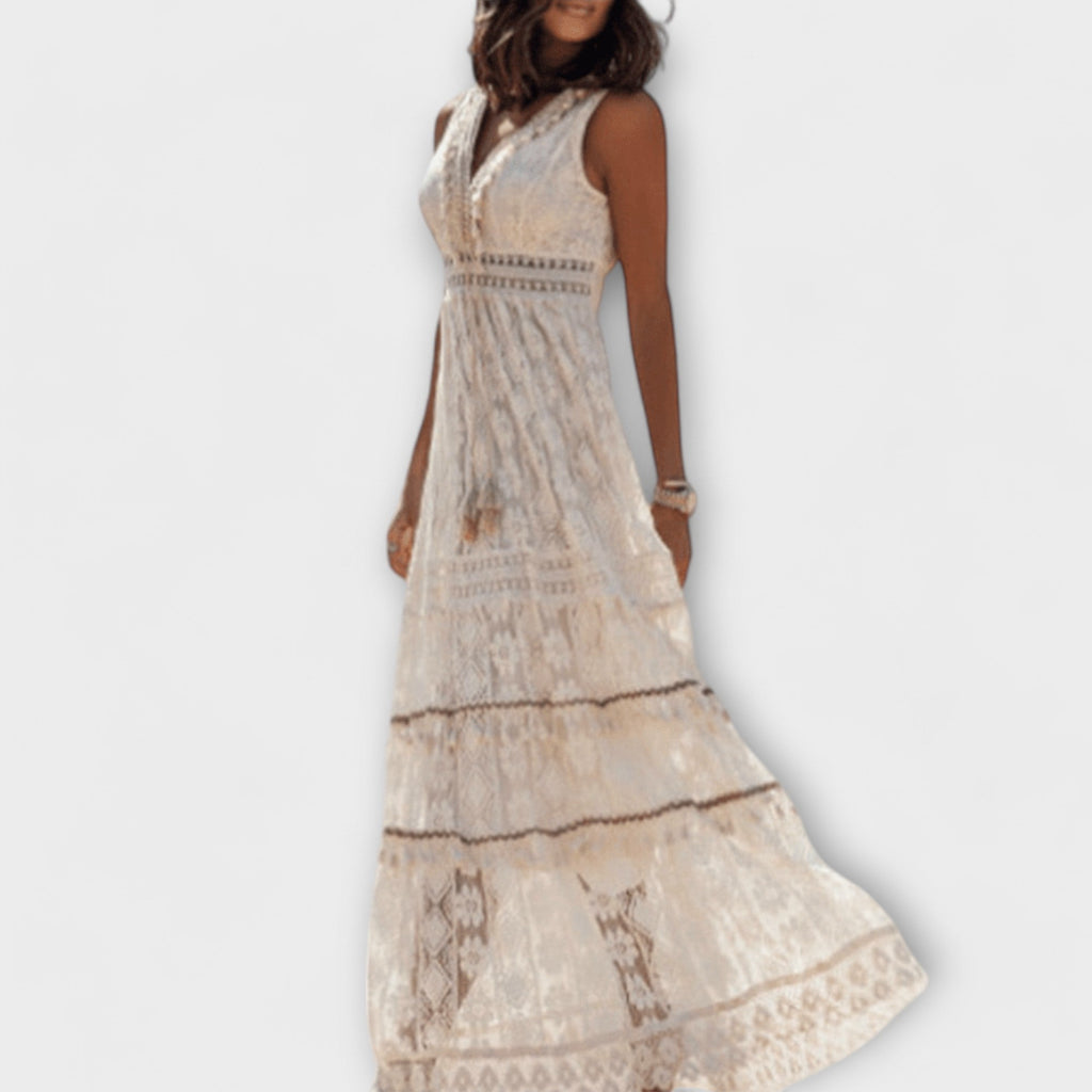 A floaty boho maxi dress with openwork detail in beige, worn in a summery outdoor setting