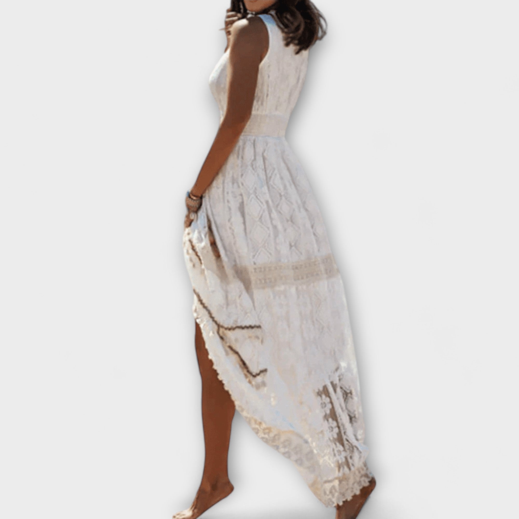 A floaty boho maxi dress with openwork detail in beige, worn in a summery outdoor setting