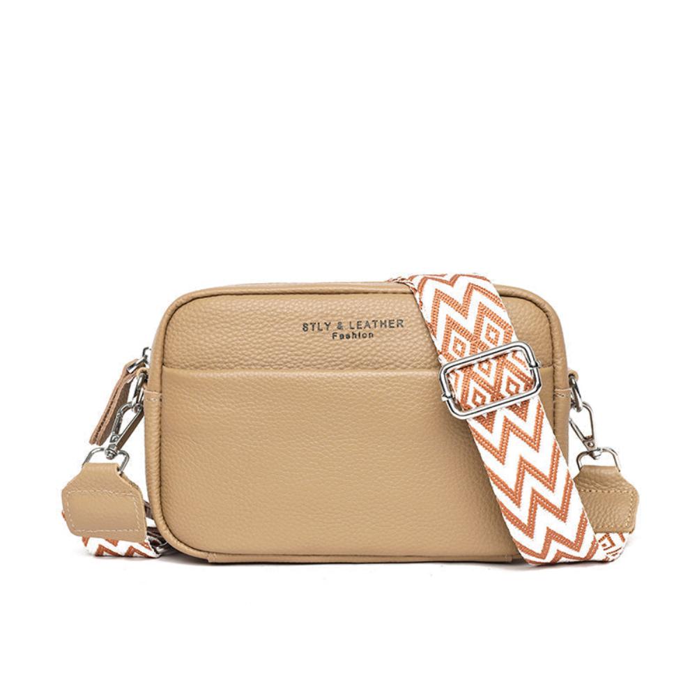 A woman wearing a timeless cross-body bag across her body while out and about