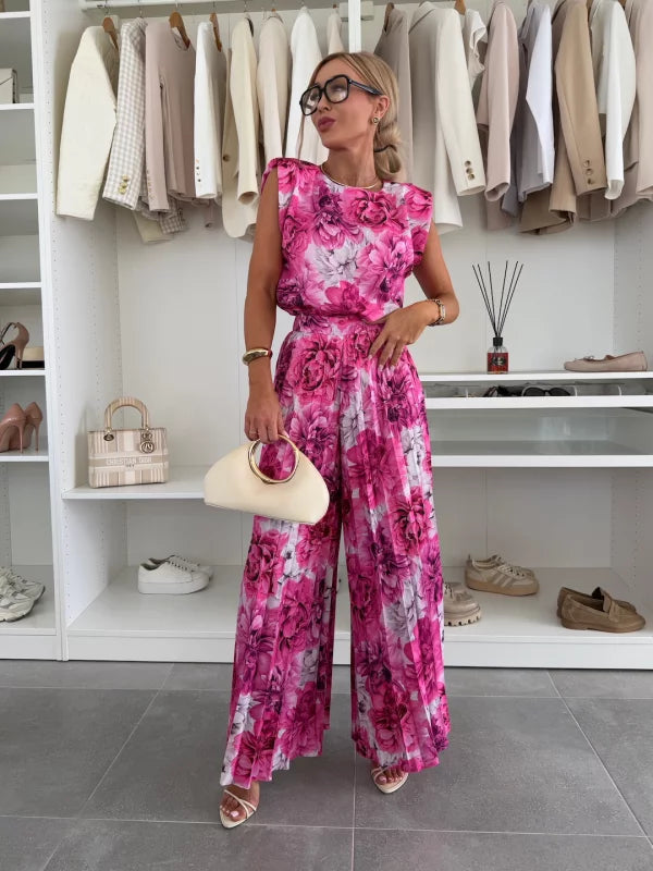 A woman wearing a structured sleeveless top with high-waisted pleated wide-leg trousers.