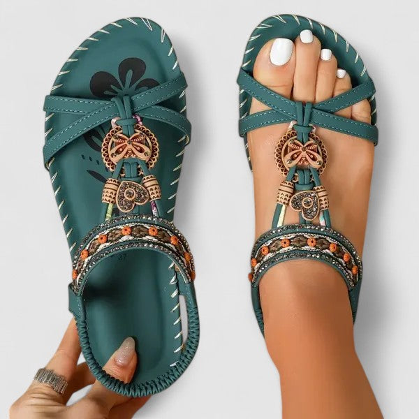 A woman standing comfortably in beige cushioned sandals with adjustable straps and a wide fit.