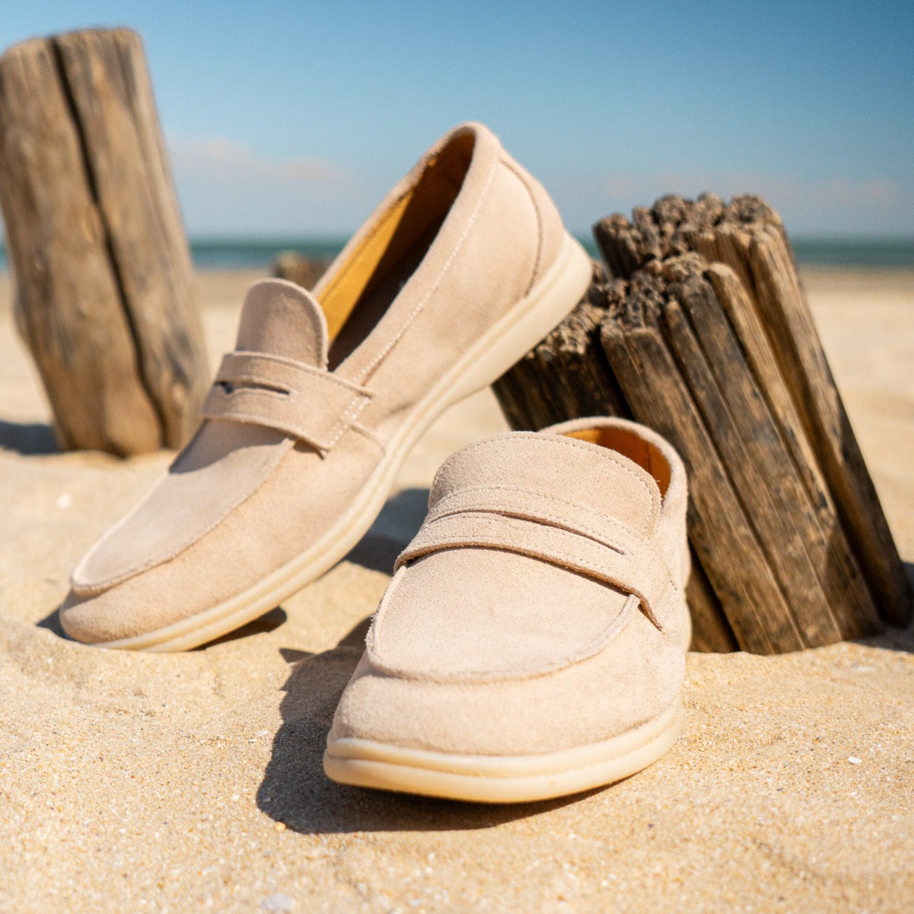 Men's classic slip-on loafers in beige and black with a neat, timeless silhouette