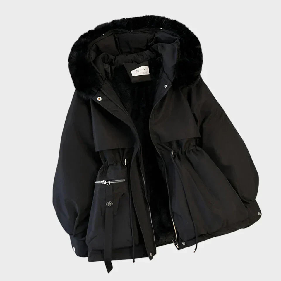 An elegant structured winter coat in camel, styled over a layered winter outfit