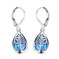 A pair of delicate drop earrings featuring a tree of life motif in blue and green tones