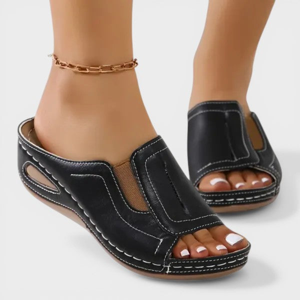 Women's orthopedic sandals in black with a cushioned footbed and lightweight strapped upper