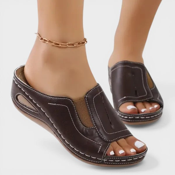 Women's orthopedic sandals in black with a cushioned footbed and lightweight strapped upper
