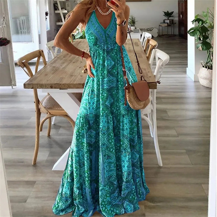A woman wearing the Attracta sleeveless boho maxi dress with adjustable straps and a flowing tiered skirt.