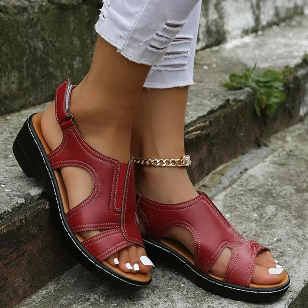A woman wearing supportive heeled sandals with a summer dress, walking comfortably and looking relaxed.