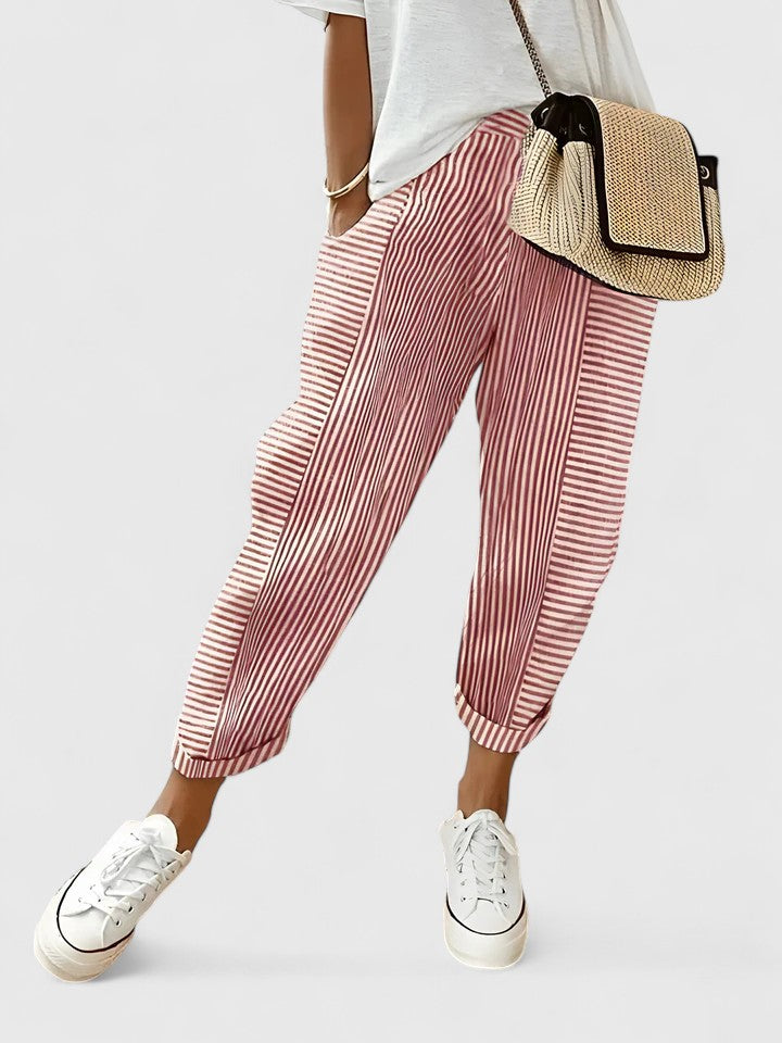 A woman wearing airy comfy summer trousers with an elastic waist and side pockets.