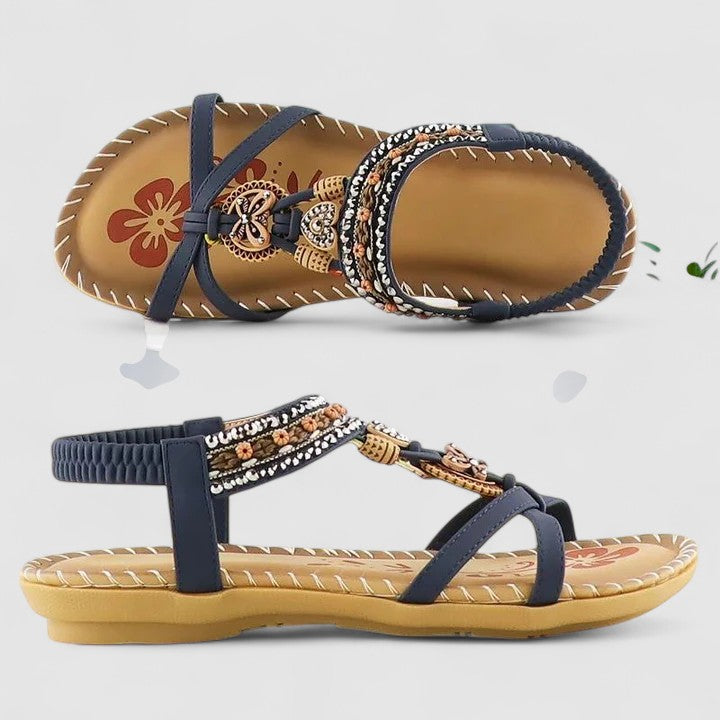 A woman standing comfortably in beige cushioned sandals with adjustable straps and a wide fit.