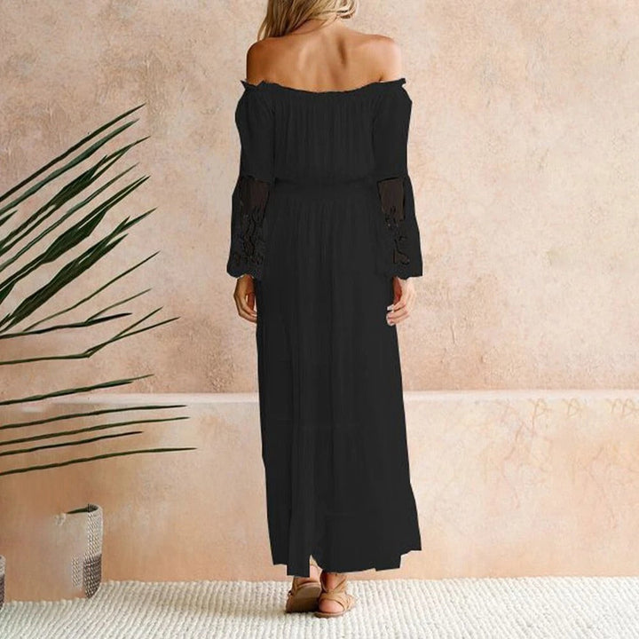 Woman wearing a romantic off-shoulder maxi dress with sheer embroidered sleeves at an evening celebration.