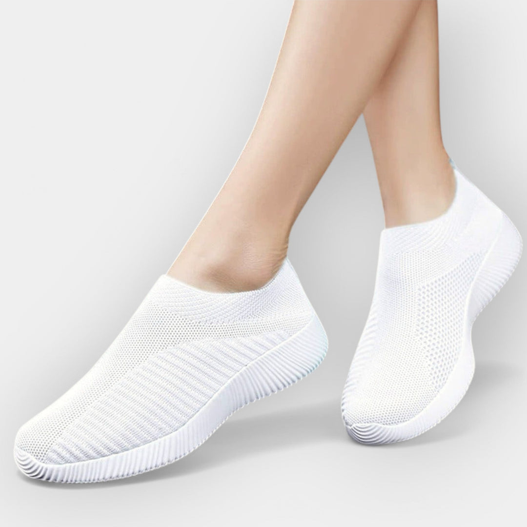 Women's breathable slip-on shoes in white with a cushioned ergonomic sole