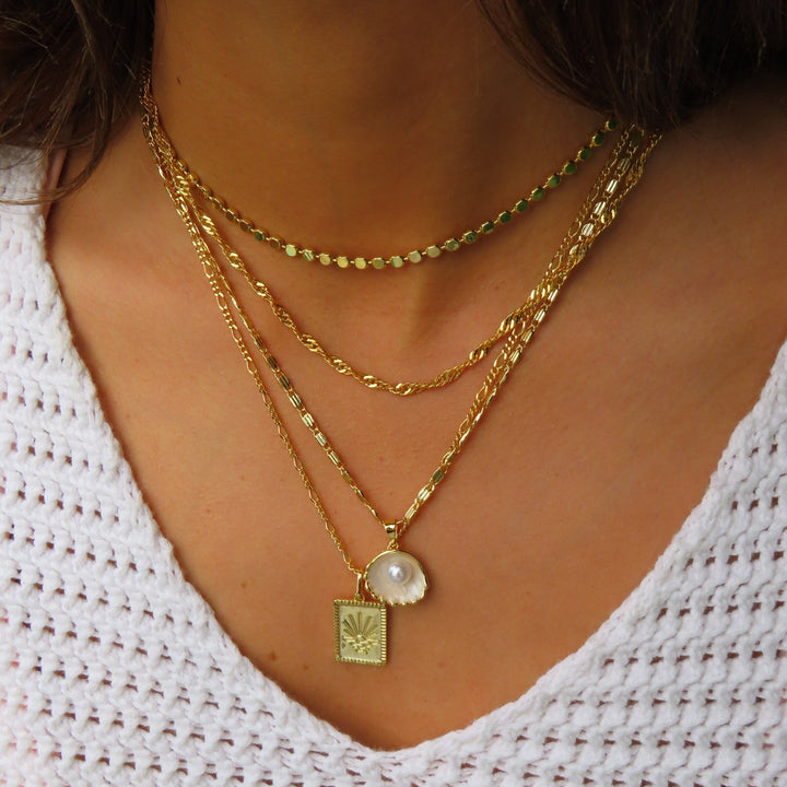 Gold radiant sun pendant necklace on fine polished chain