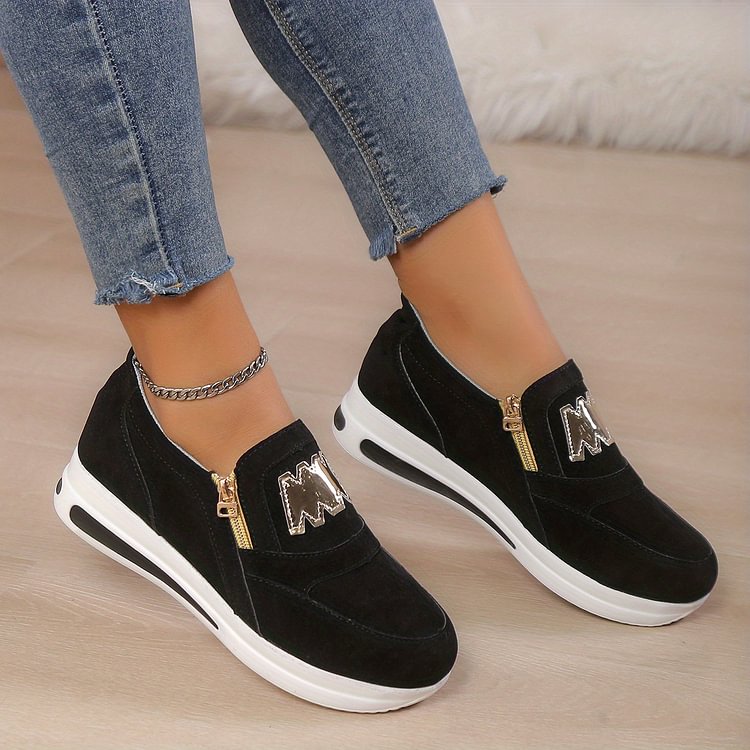 Women's black comfort slip-on shoes with a cushioned ergonomic sole and clean minimal design
