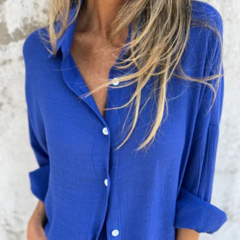 A woman wearing a buttoned polo top with matching flowing shorts
